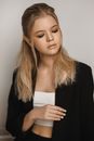 Young Blond Woman Wearing Short White Top and Black Jacket