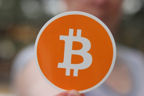 Orange Bitcoin Sticker in Close Up Photography