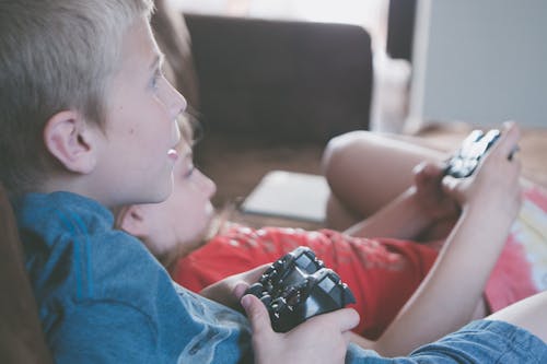 Two Boy and Girl Holding Game Controllers