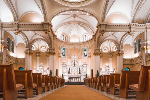 Stunning view of a gothic cathedral's interior featuring arches, pews, and an ornate altar.