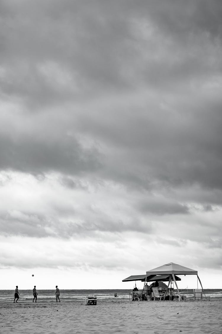 Grayscale Photo Of People Having Fun On Tropical Beach Resort