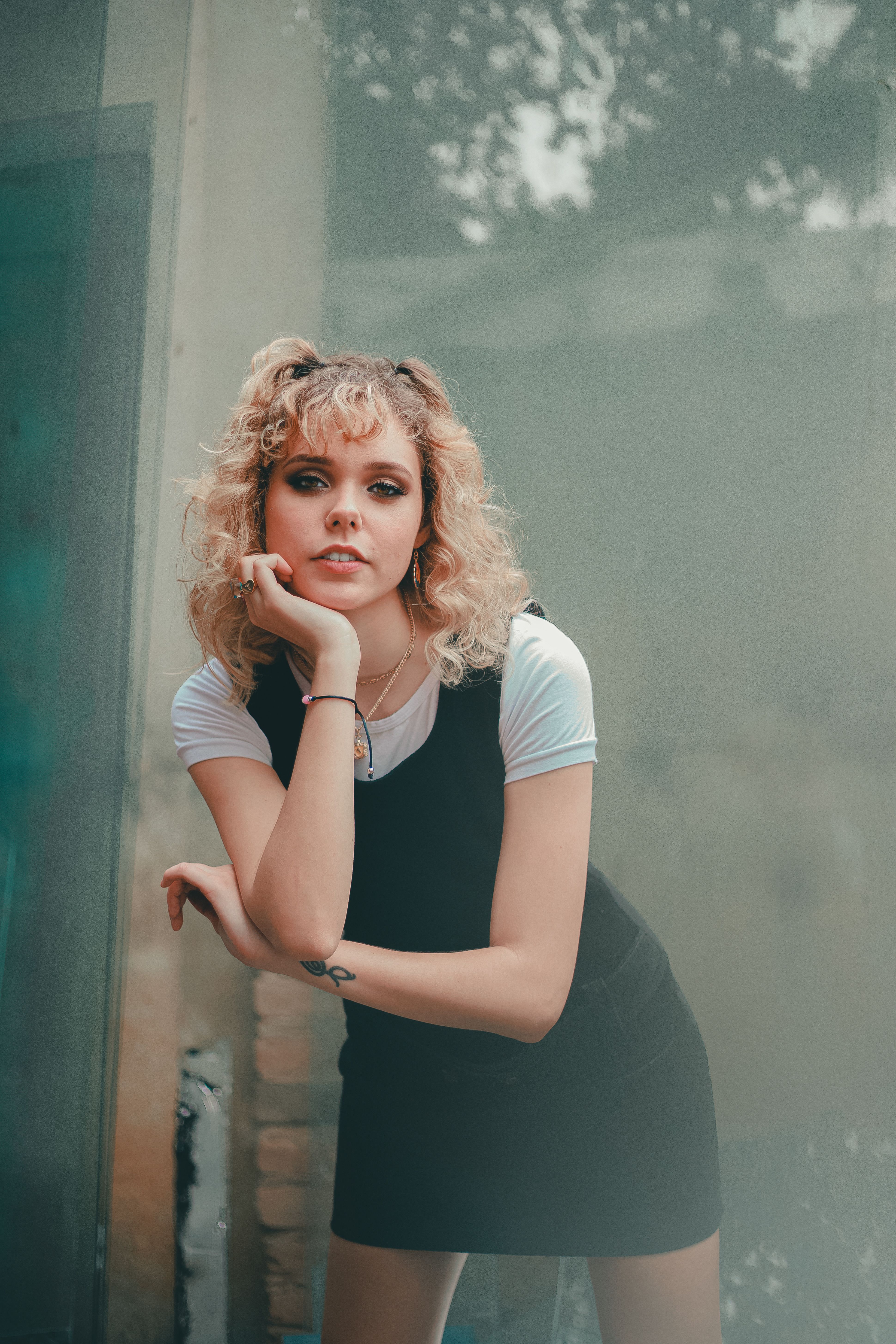 A Woman in Black Dress with Her Hand on Her Chin · Free Stock Photo