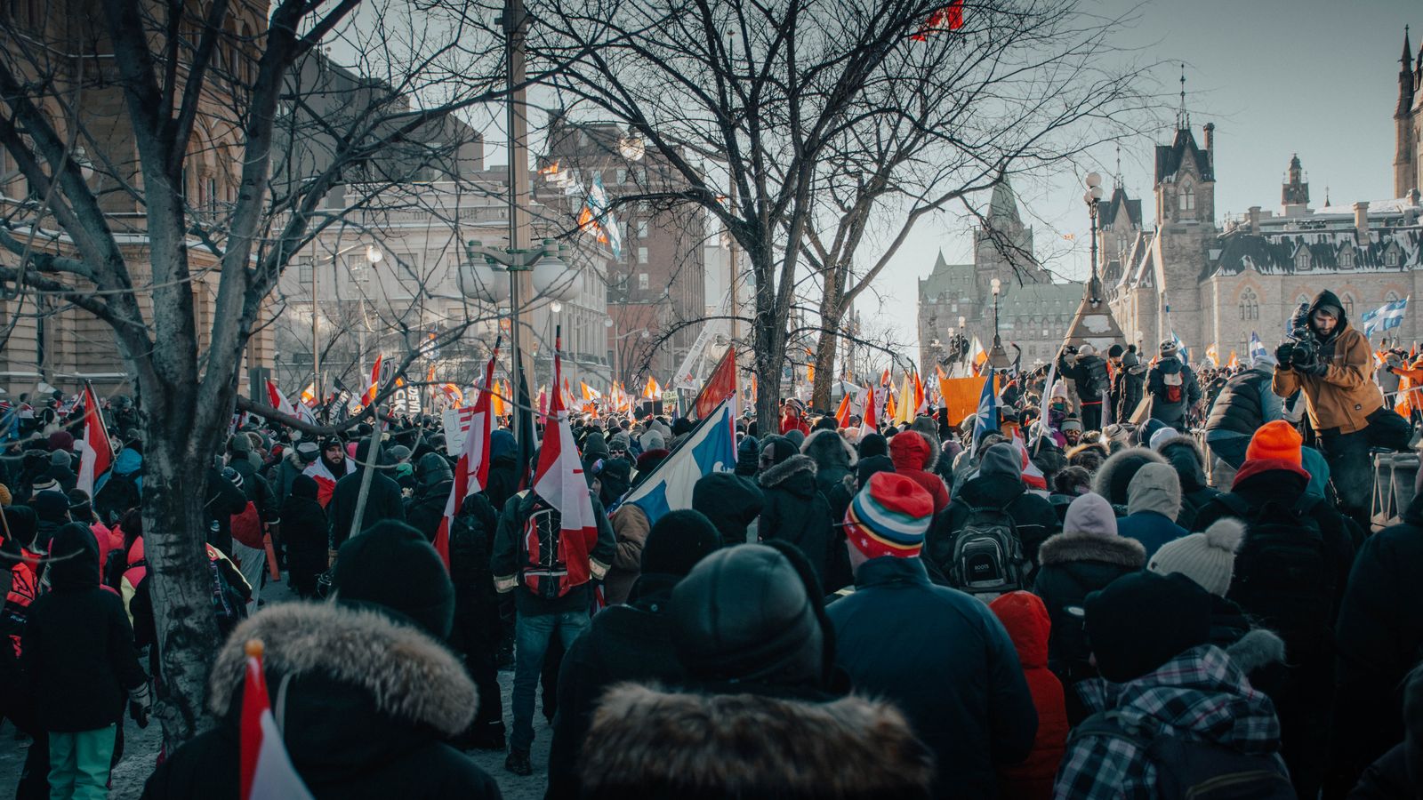 Crowd gathered in Ottawa, Canada for a street protest on a cold winter day.
