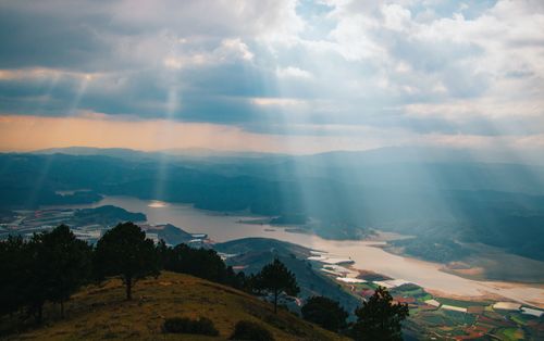 Free Breathtaking landscape of mountains and water with dramatic sunrays breaking through clouds. Stock Photo