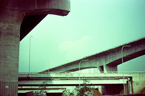 Film Photograph of Concrete Building and Bridges in City
