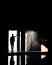 Silhouette of Man Standing on the Doorway