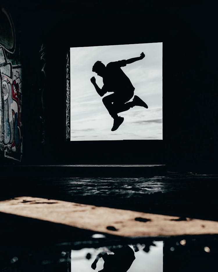 Silhouette Of A Man Jumping In An Abandoned House