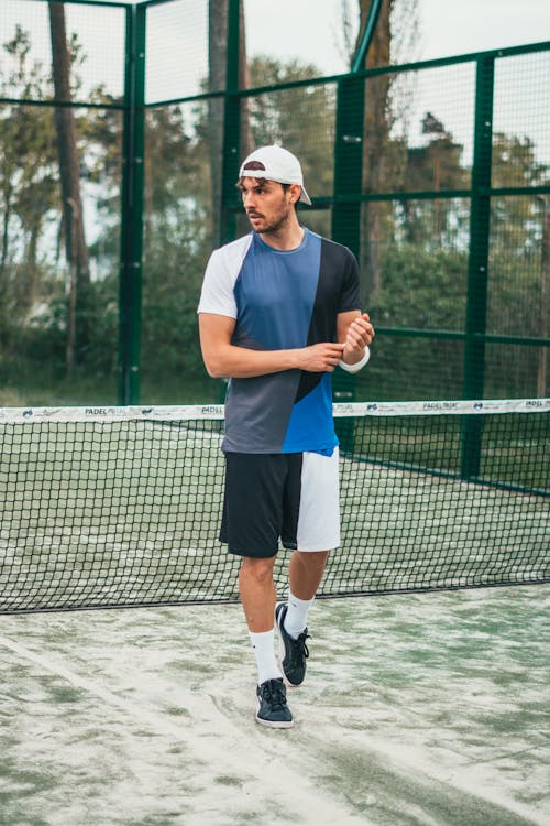 Man Wearing Blue and White Crew-neck Shirt and Shorts