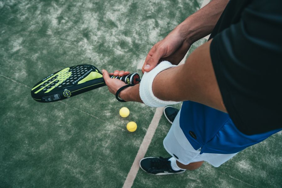 Padel player mid-rally on court