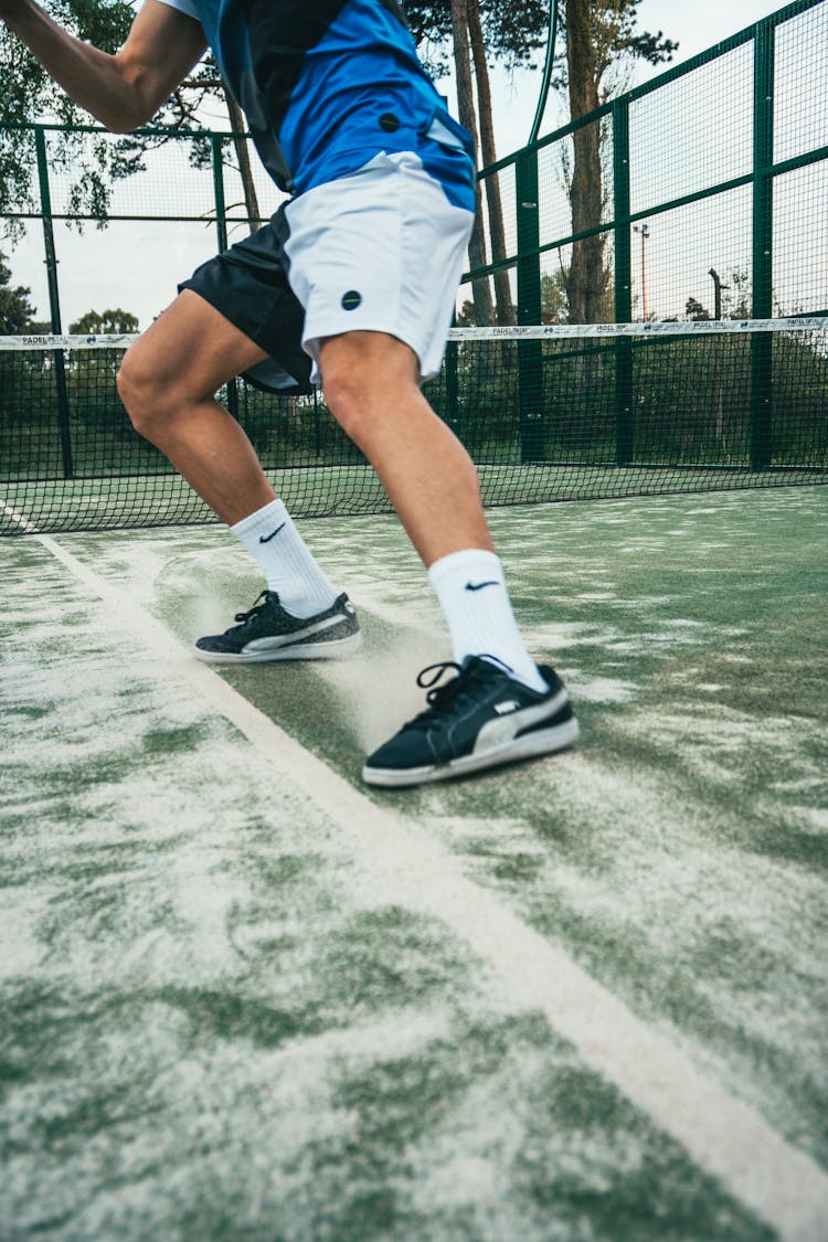 Close-up Photo Of Man Standing On Tennis Court