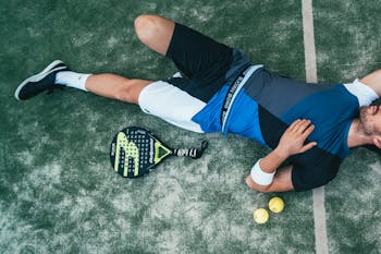 Man Lying Beside on Green Tennis Balls