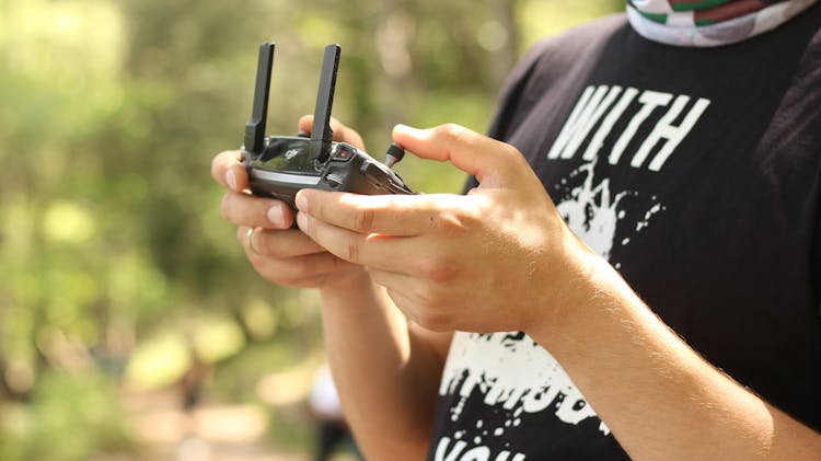 Person Holding Radio Controller At Daytime