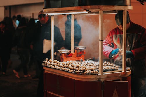 Free A Street Vendor Selling Chestnuts Stock Photo