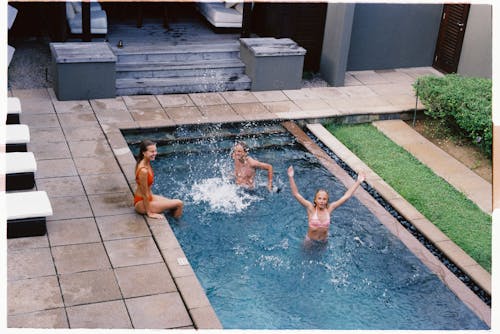 Women and Girl Having Fun in the Swimming pool