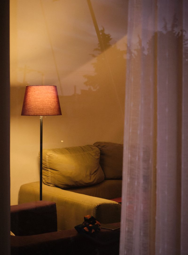 Calm apartment living area at night with layered low lighting