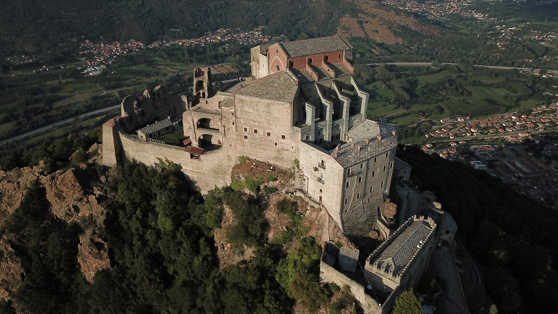 Stunning aerial shot of Sacra di San Michele, a historic abbey in Piedmont, Italy, showcasing its architectural beauty.