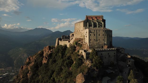 Majestic aerial shot of Sacra di San Michele on a mountain in Piemonte, Italy.