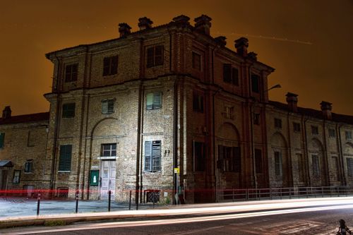 Free Illuminated facade of a historic building in Stupinigi, Italy at night with light trails. Stock Photo