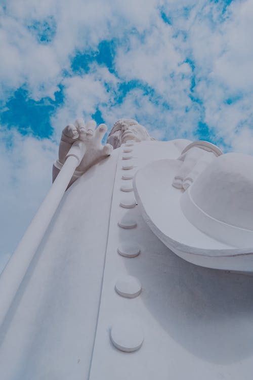 Free Low Angle Shot of White Concrete Statue Under Cloudy Sky Stock Photo