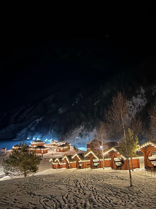 Free Illuminated cabins in snowy, mountainous landscape at night in Chechnya. Stock Photo
