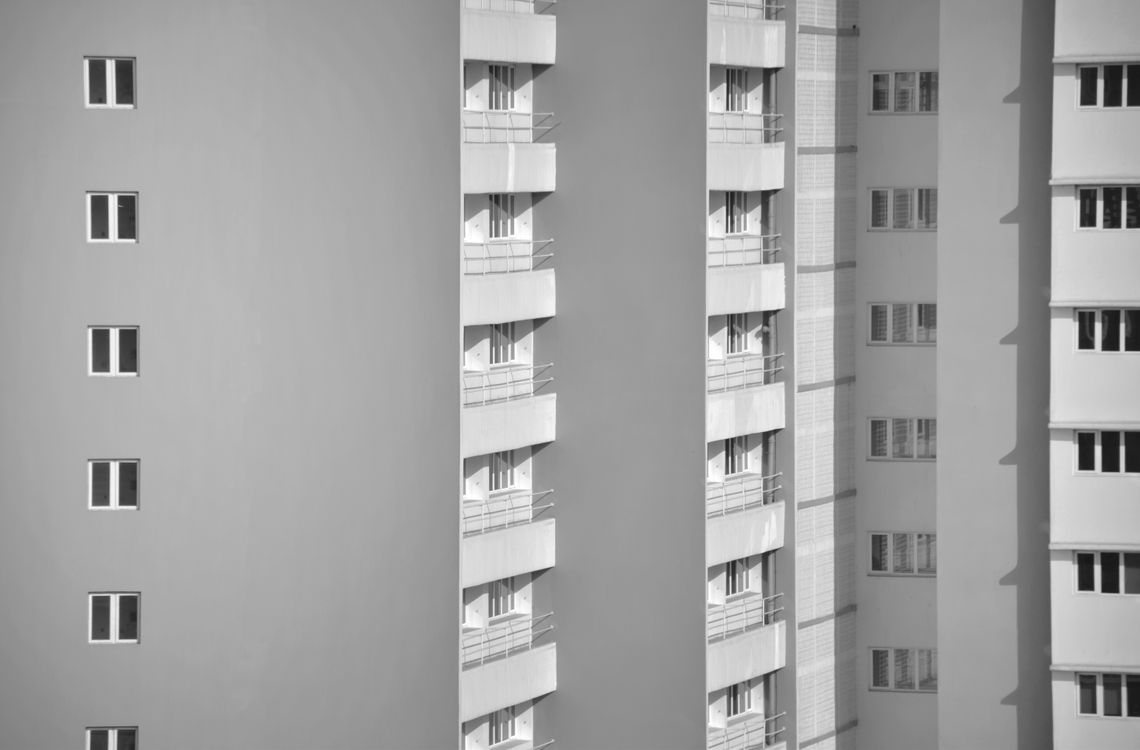 Grayscale Photo of a Gray Concrete Building · Free Stock Photo