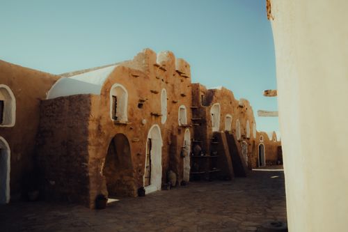 Free Explore Tunisia's traditional Berber architecture with warm stone and unique design. Stock Photo