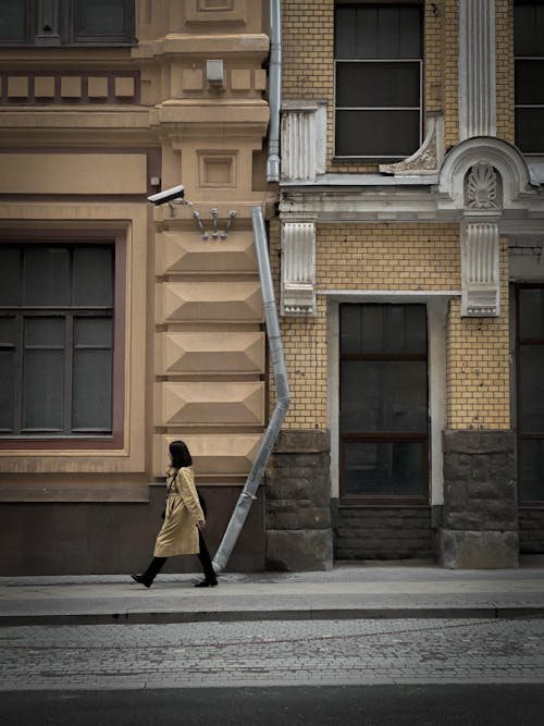 Free A Side View of a Woman Walking on the Street Stock Photo