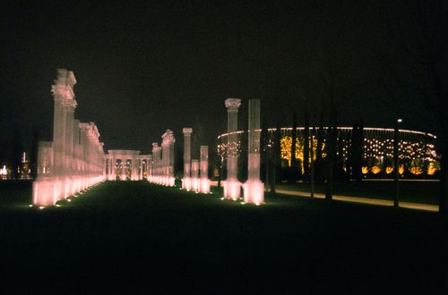 Free Glowing pillars and illuminated building at night, creating an atmospheric scene. Stock Photo