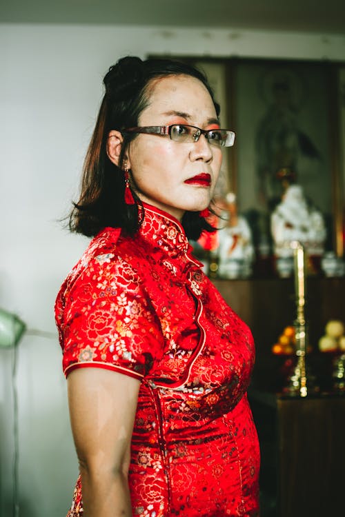 Photo of a Woman Red Lips Wearing a Red Qipao