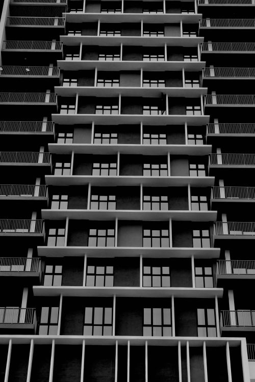 Free Architectural symmetry of a modern building facade in George Town, Penang captured in black and white. Stock Photo