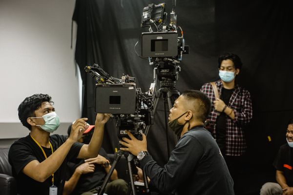 Film crew rigging a camera on set - photo by BSM Rental on Pexels