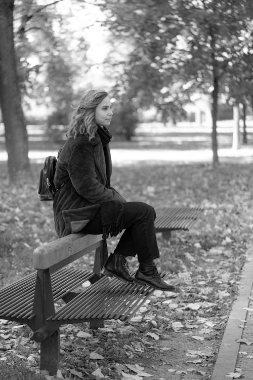 Free A Woman Sitting on the Wooden Bench Stock Photo