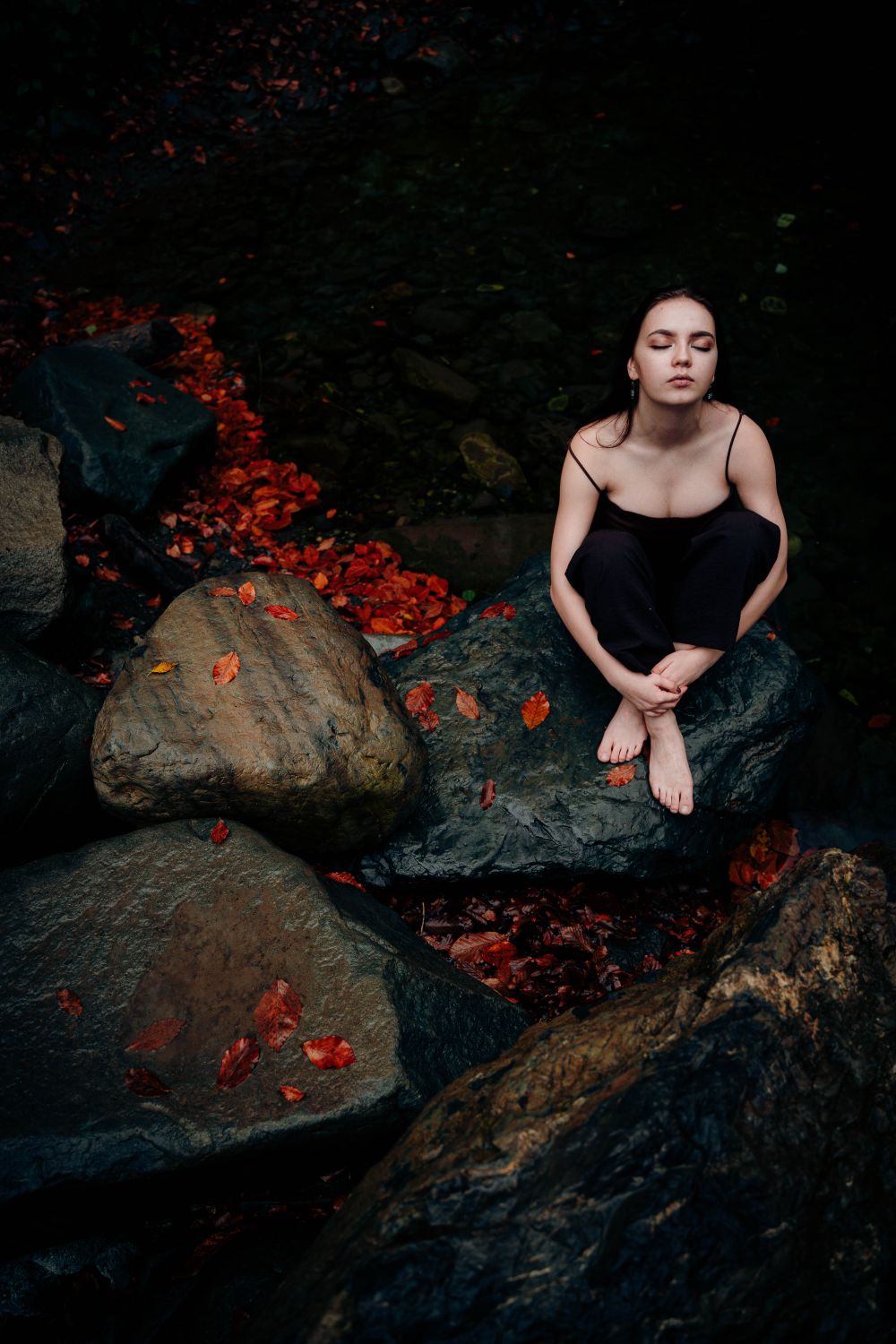 Woman with Eyes Closed Sitting on Rock · Free Stock Photo