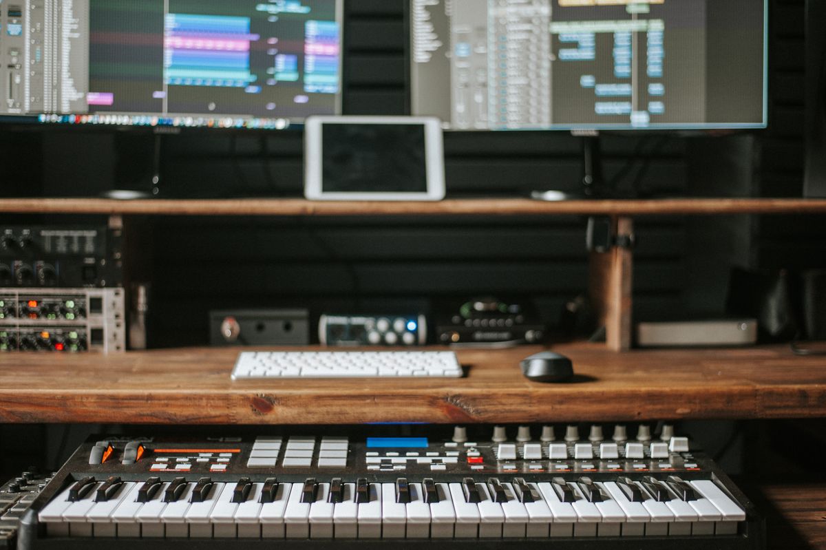 Audio studio setup with laptop and production equipment