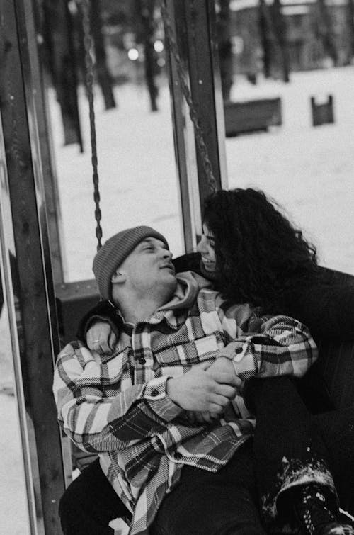 A Grayscale Photo of a Couple Having Conversation