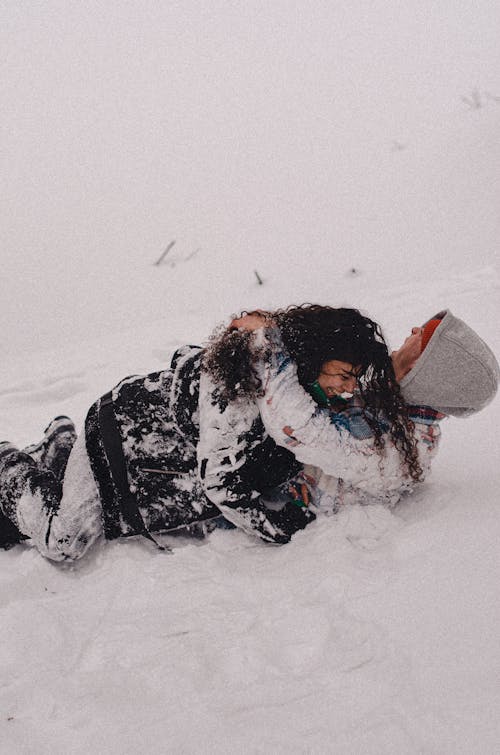 A Couple Lying on Snow-Covered Ground