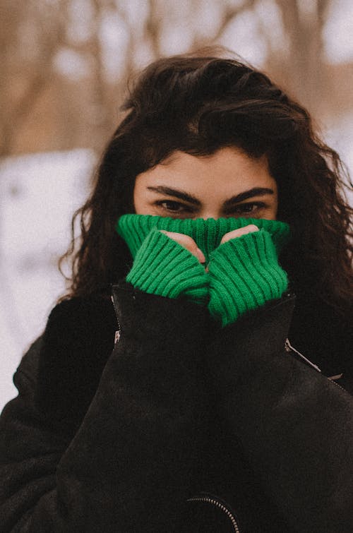 Woman Covering Half of Her Face with Sweater Outside in Winter 