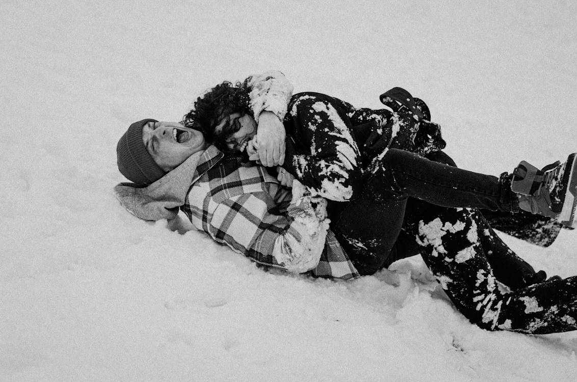 Free Monochrome Photograph of a Couple Playing on the Snow Stock Photo