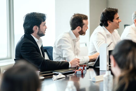 People in formal attire engaging in a collaborative business meeting.