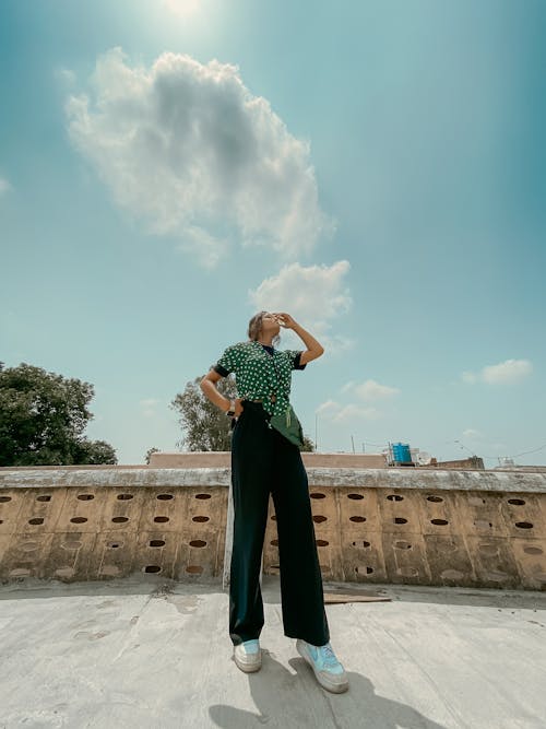 Young Woman in a Casual Outfit Standing on a Terrace 