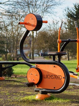 Outdoor stationary exercise bike by Wicksteed in a park, perfect for fitness enthusiasts.