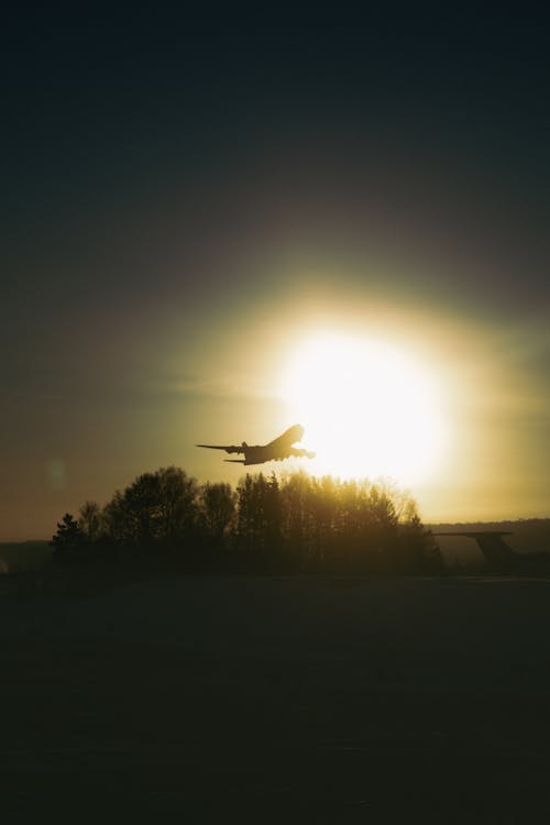 Free Silhouette of Airplane on Mid Air during Sunset Stock Photo