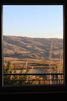 Stunning mountain landscape seen through a window, showcasing nature's beauty