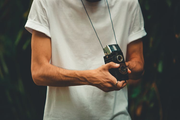 Man Holding A Vintage Camera 