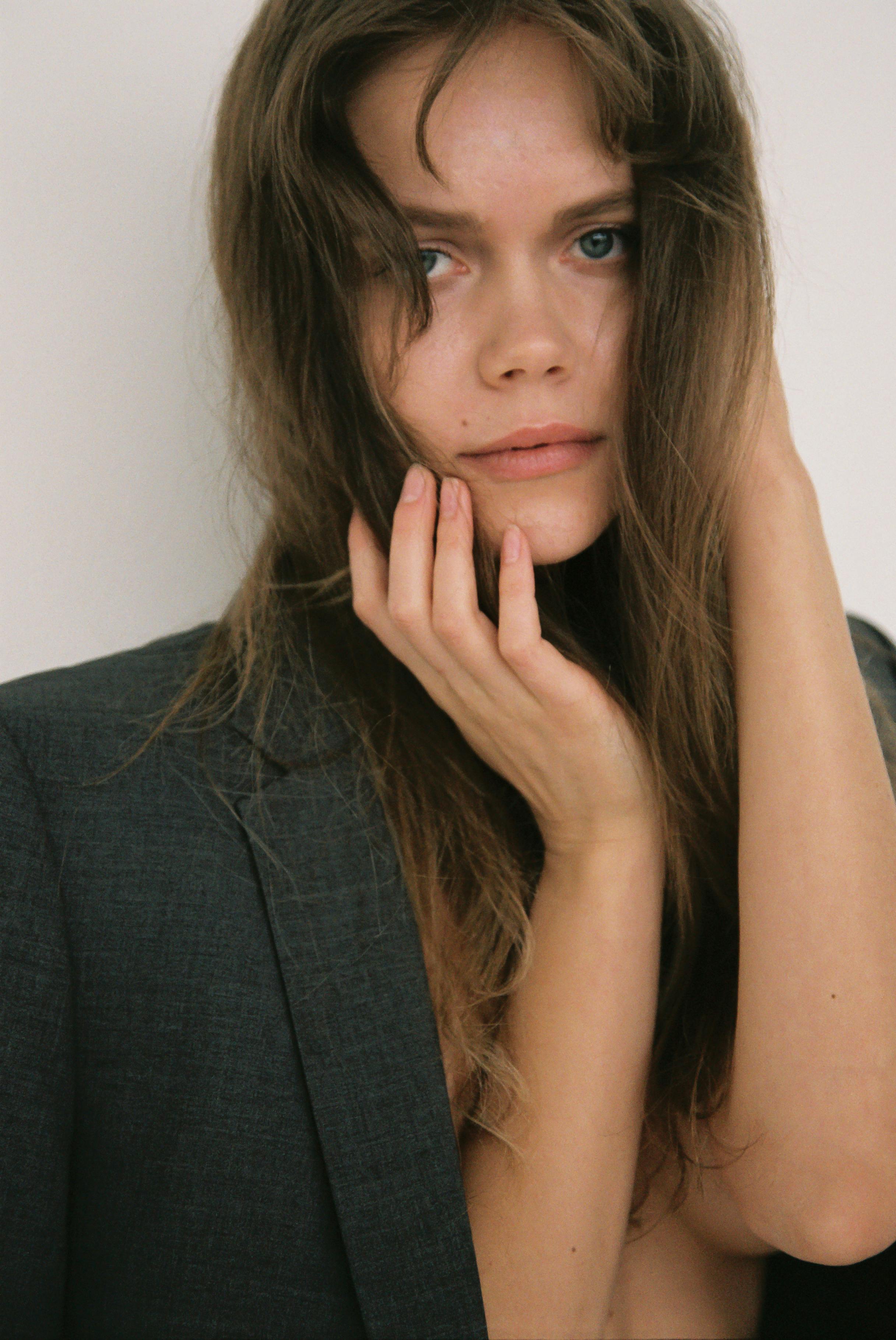 Close-up portrait of a woman with long hair, wearing a jacket.