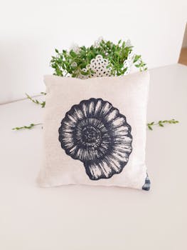 Stylish throw pillow featuring a seashell motif, ideal for adding a beachy touch to home decor.