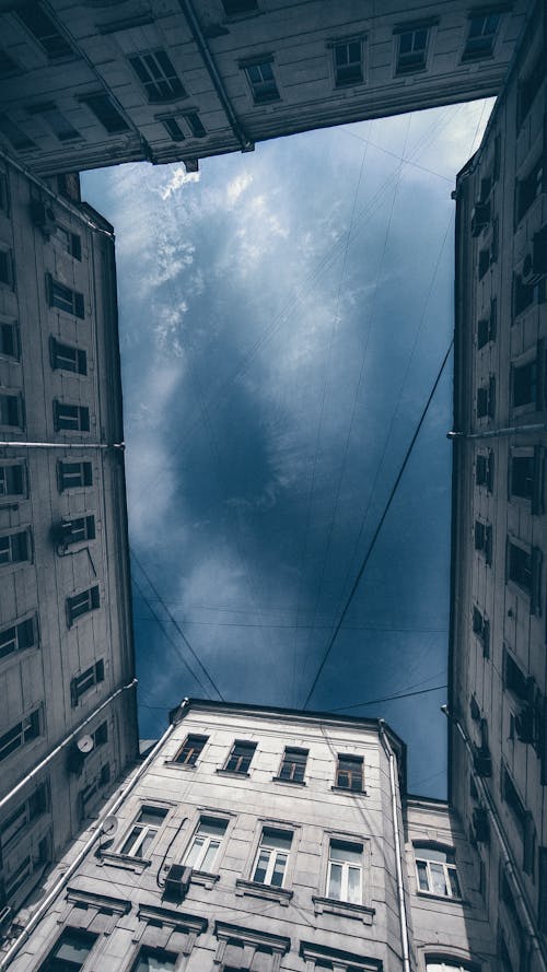 Low-Angle Shot of Buildings Under a Blue Sky