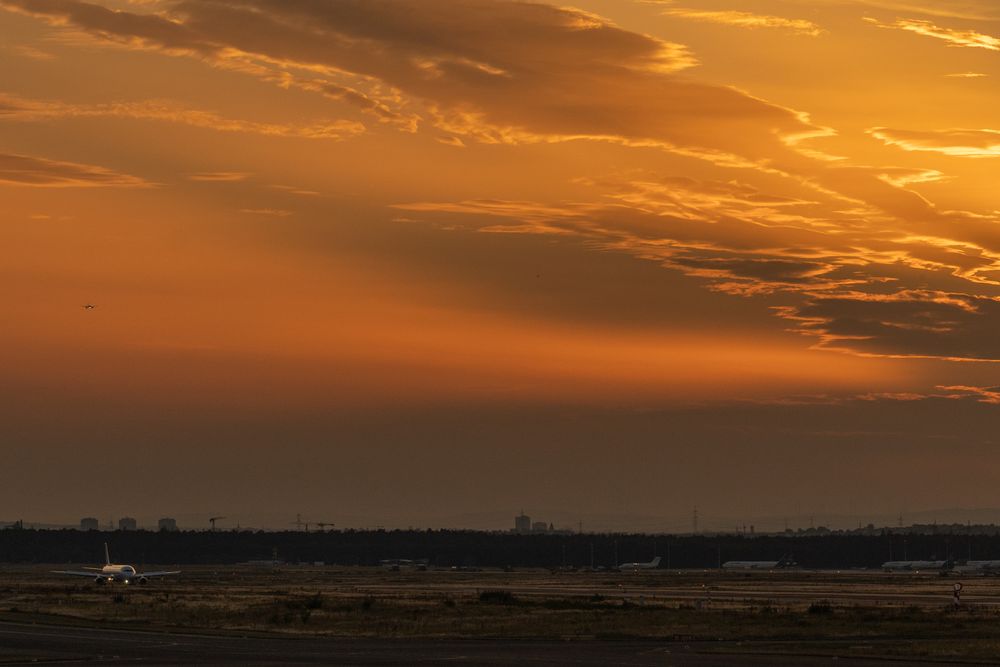 Airplane on the runway during a golden sunset