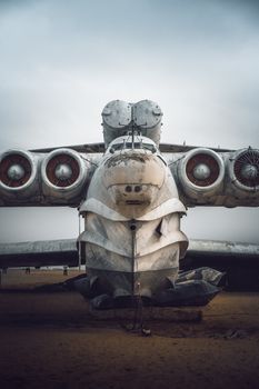 A vintage aircraft resting on a sandy beach, showcasing unique engineering.