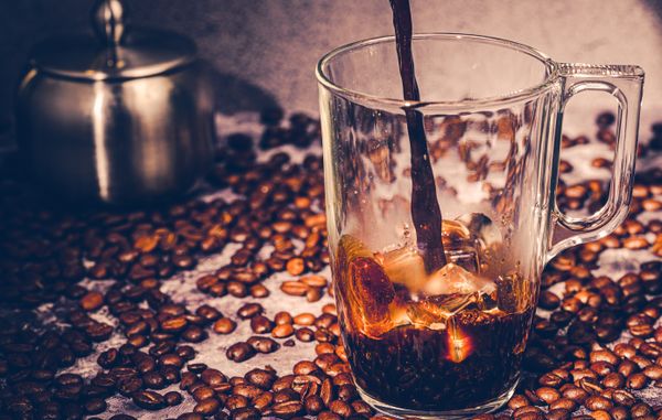 Cold brew poured over ice and scattered roast beans — photo by Jana Ohajdova on Pexels